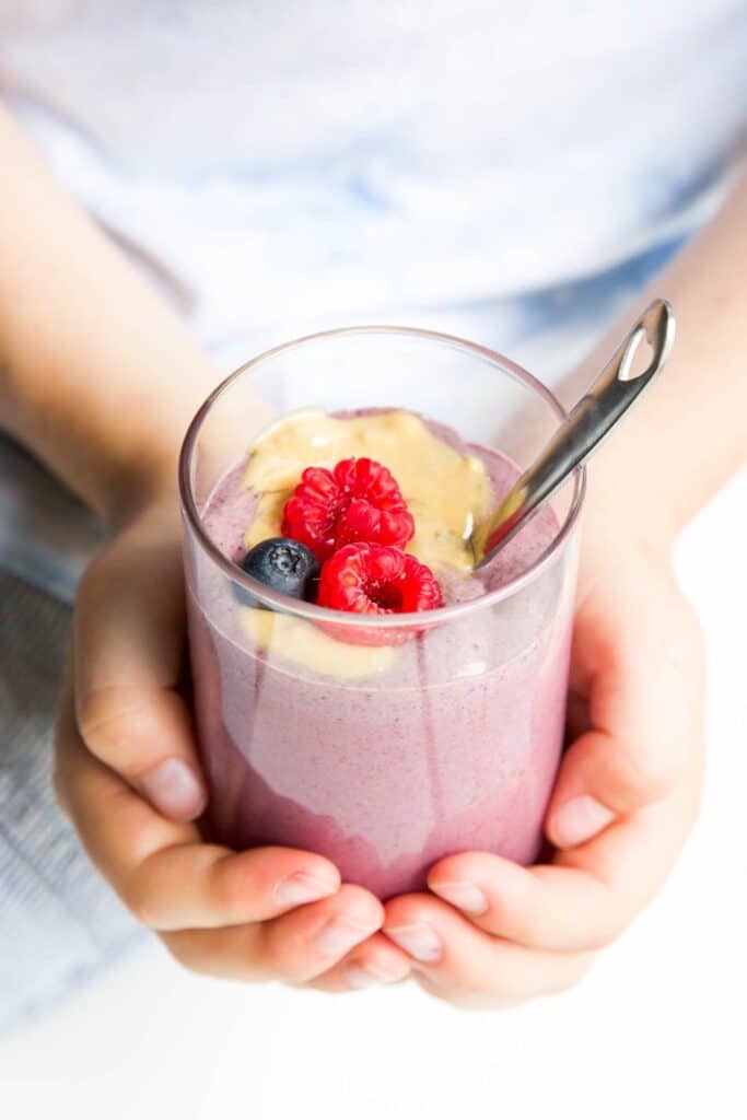 Side Shot of Childs Hands Holding Jar of Overnight Oats