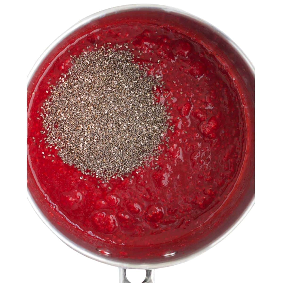 Heated Raspberries in Pan with Chia Seeds on Top.