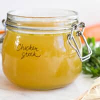 Side on Shot of Homemade Baby Chicken Stock in Glass Storage Jar.