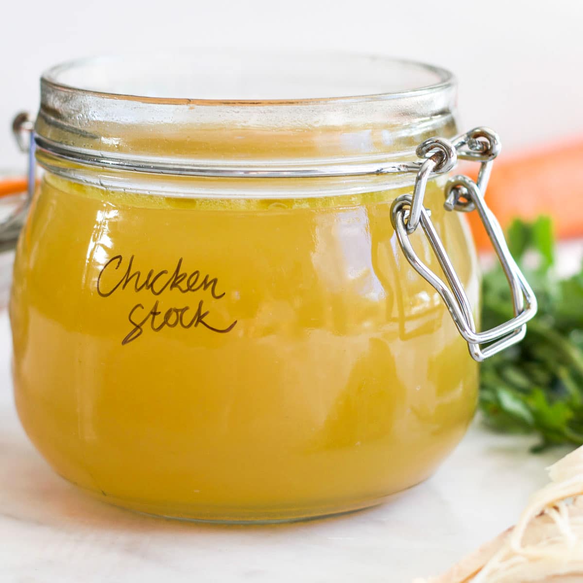 Side on Shot of Homemade Baby Chicken Stock in Glass Storage Jar. 