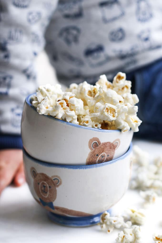 Homemade Popcorn in Bowl with Child Sitting in Background