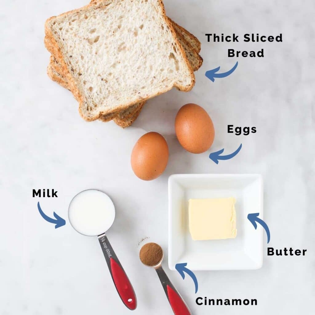 Top Down View of Eggy Bread Ingredients (Bread, Eggs, Milk, Cinnamon and Butter