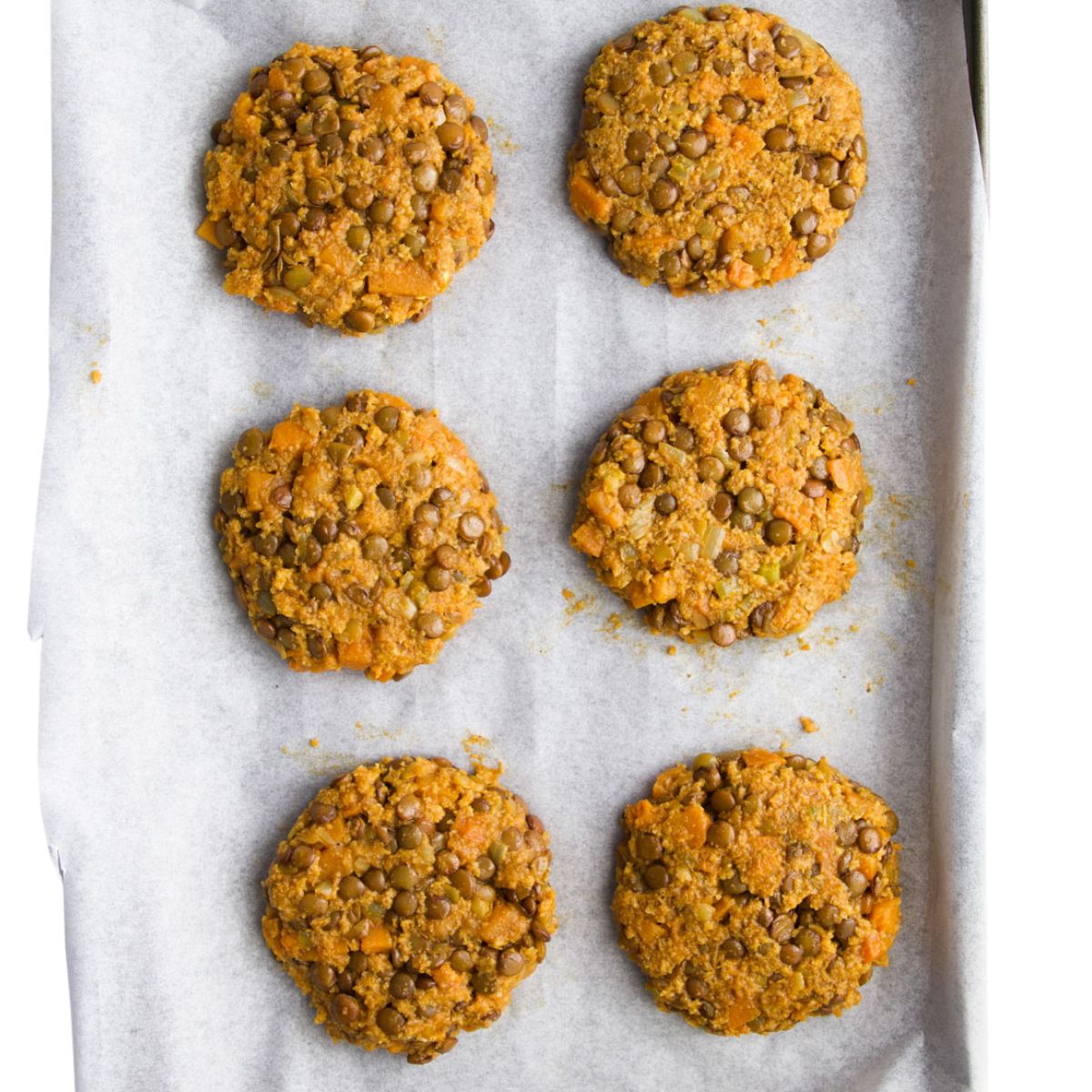 Six Lentil Burgers Uncooked on Tray.