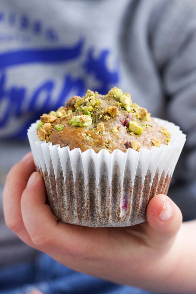 Child Holding a Pistachio and Raspberry Muffin