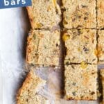 Quinoa Bar Pinterest Pin. Cut Quinoa Bars on Chopping Board with Text Overlay "Quinoa Breakfast Bars"