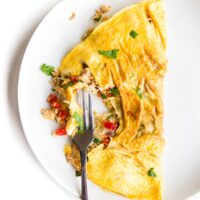 Tuna Omelette on White Plate with Fork Removing Section