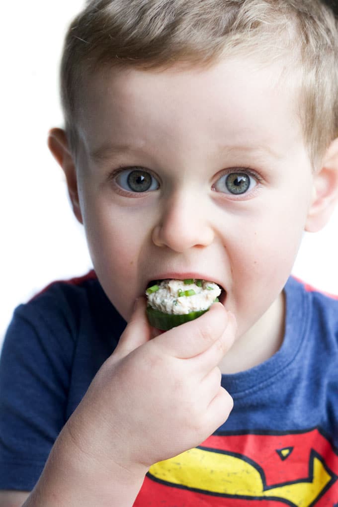 Child Eating Healthy Tuna Salad on Cucumber