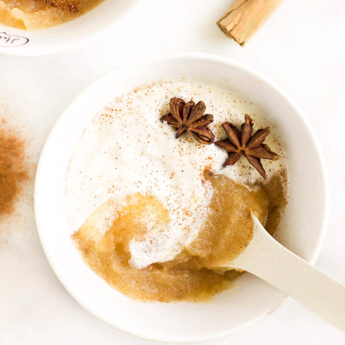 Yogurt Topped with Apple Puree and Star Anise in White Bowl.