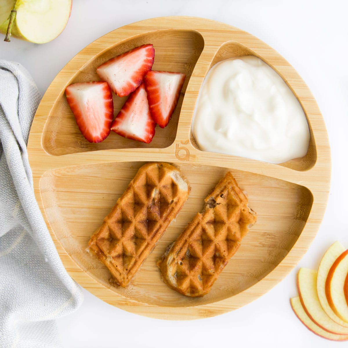 Fingers of Apple Waffles Served on Baby Plate with Yogurt and Strawberries.