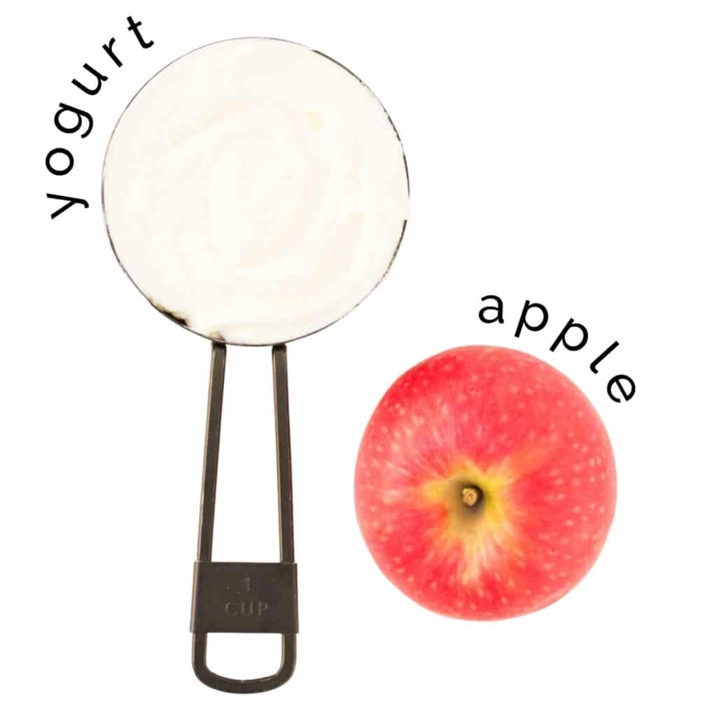 Flat Lay of Yogurt in Measuring Cup and an Apple 