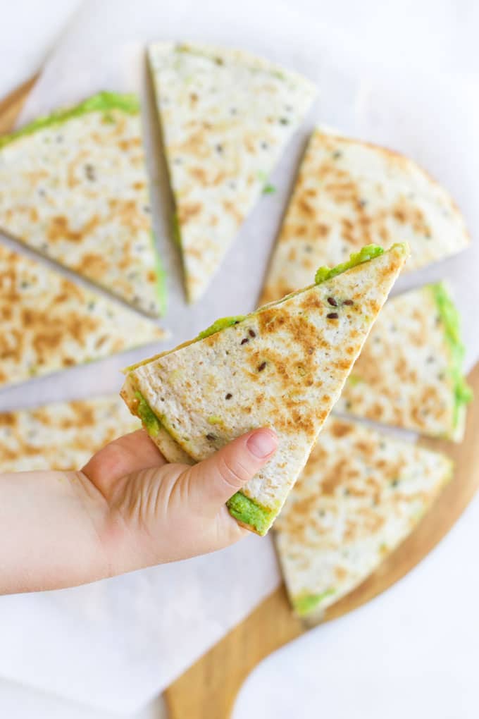 Child Grabbing an Avocado Quesadilla from Board