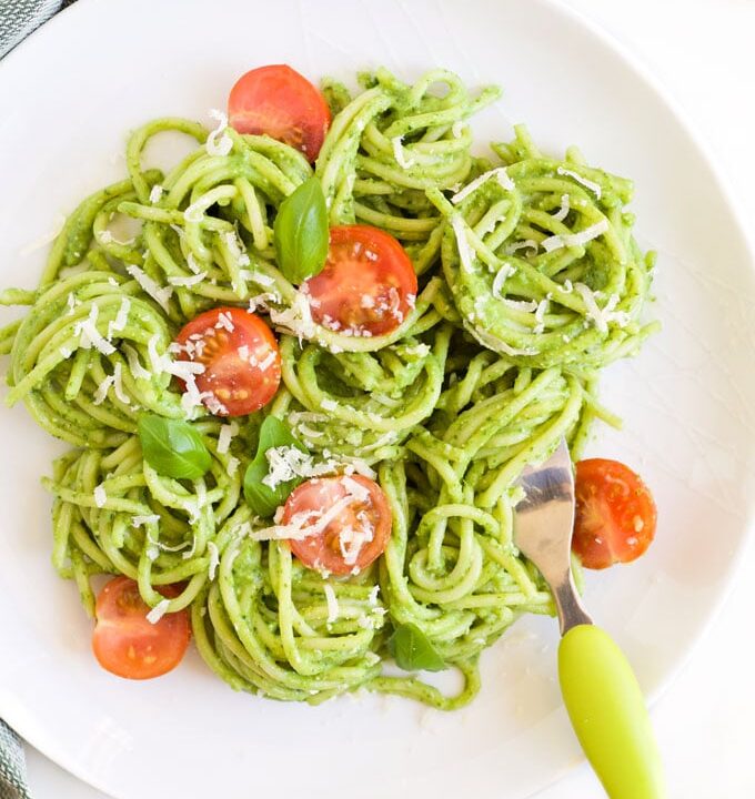 Plate of Avocado Spinach Spaghetti Topped with Cherry Tomato