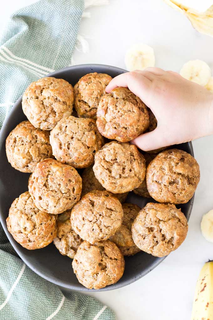 Child Grabbing a Banana Muffin from Plate