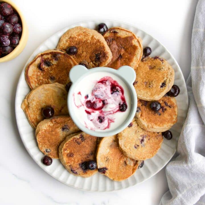 Baby Blueberry Pancakes on Plate with Blueberry Yogurt Dip in Centre.