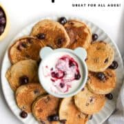 Pinterest Pin for Baby Blueberry Pancakes with Image of Plate with Blueberry Pancakes and Yogurt Dip.