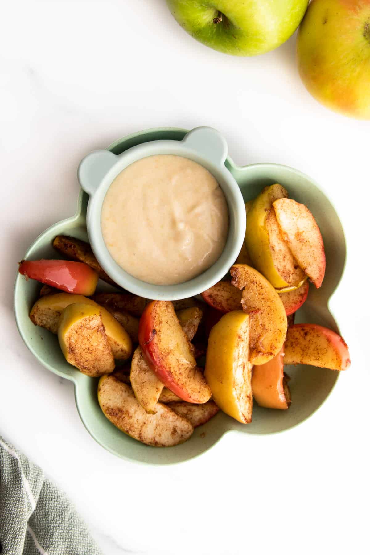 Baked Apple Slices in Flower Bowl With Peanut Butter Dip. 