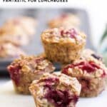 Pinterest Pin for Baked Oatmeal Cups Showing the Baked Oatmeal Cups on a Marble Tray with Baking Tray in Background. Oatmeal Cup in Front Has Bite Removed.