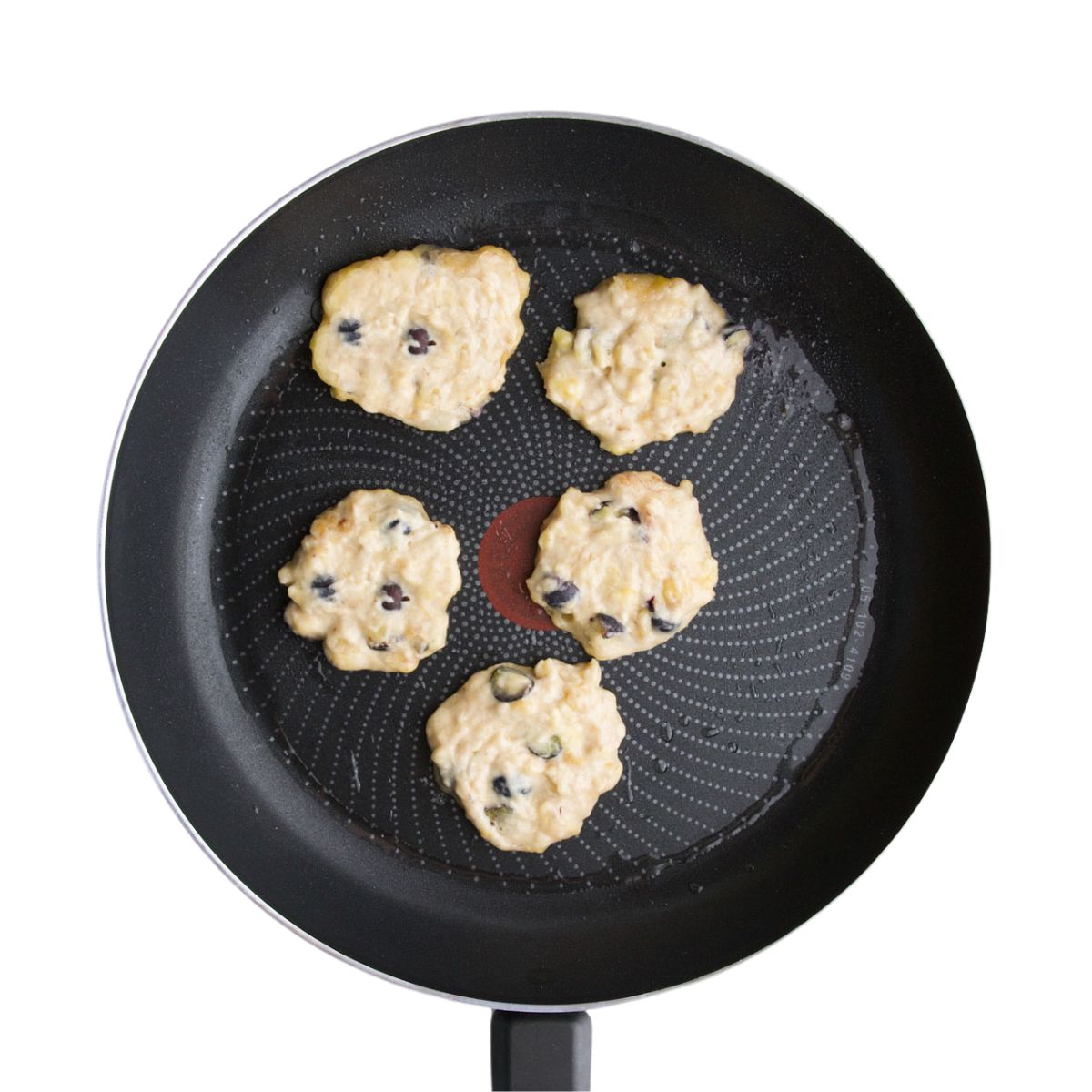 Raw Banana Blueberry Fritters in Frying Pan.