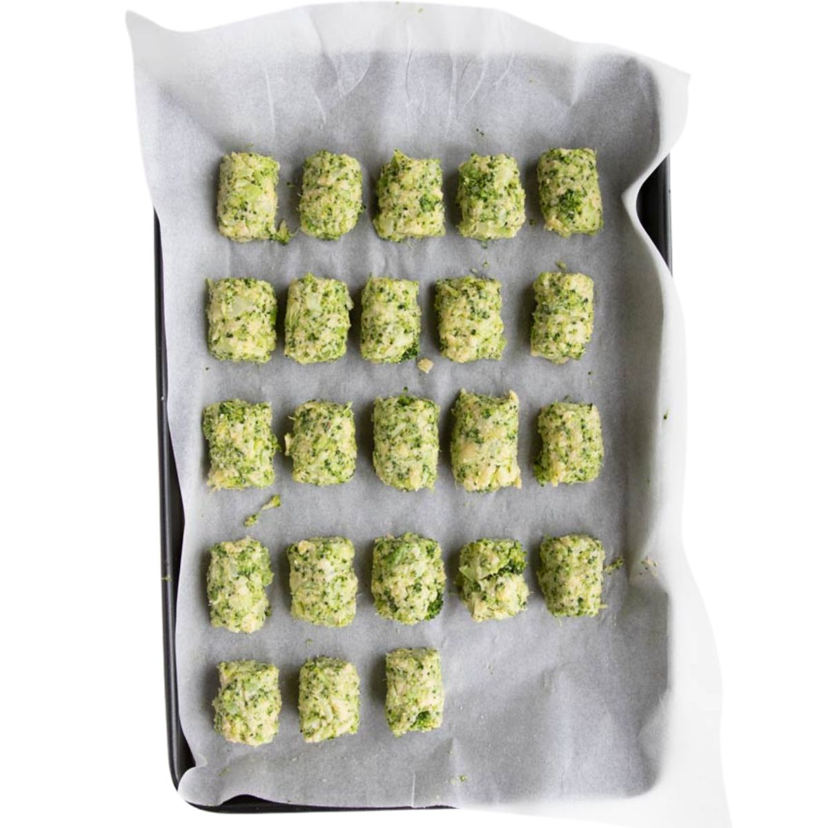 Uncooked Broccoli Tots on Baking Sheet.