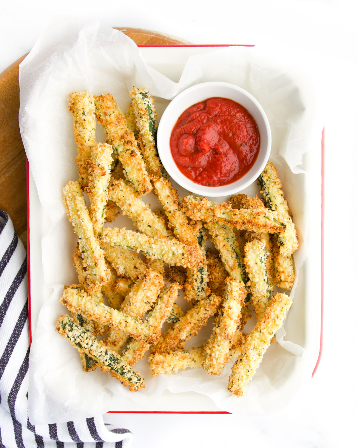 Courgette (Zucchini) Fried in Tray with Small Bowl of Pizza Sauce. 