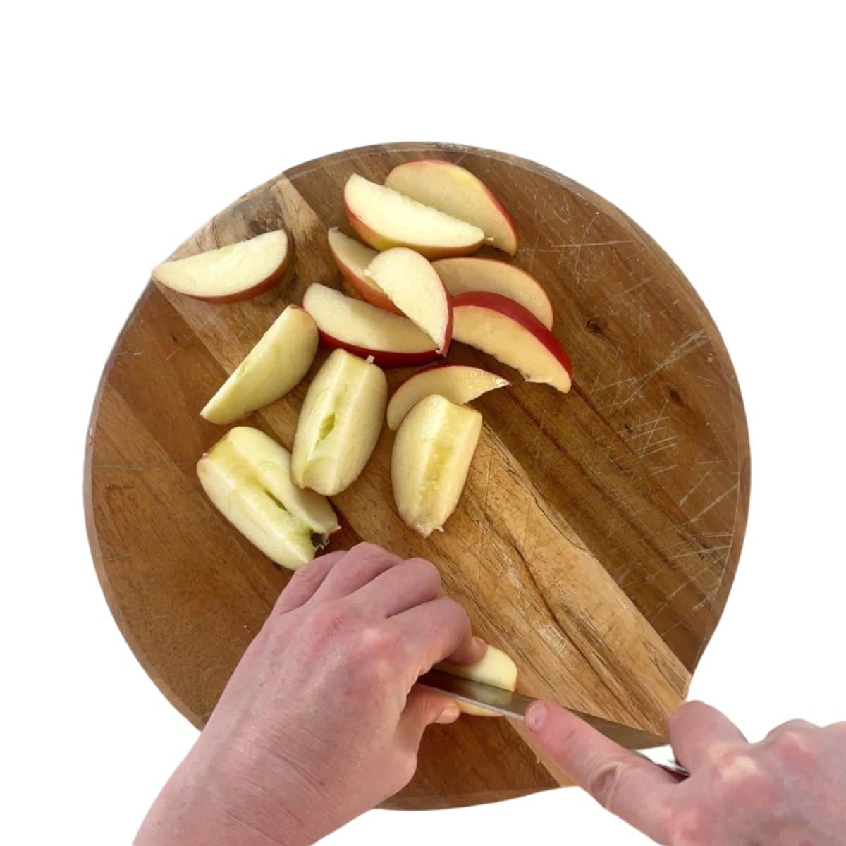 Hands Cutting Apple into Slices. 