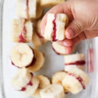 Child Holding Frozen Banana Treat with Bite Out