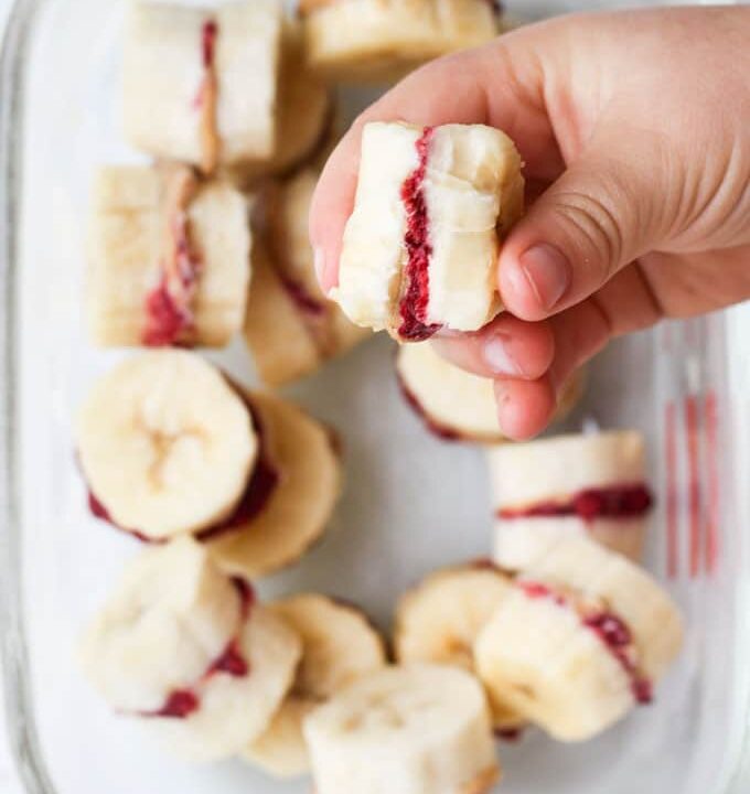 Child Holding Frozen Banana Treat with Bite Out