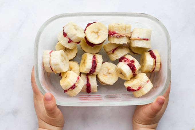 Child Holding Container of Frozen Banana Treats