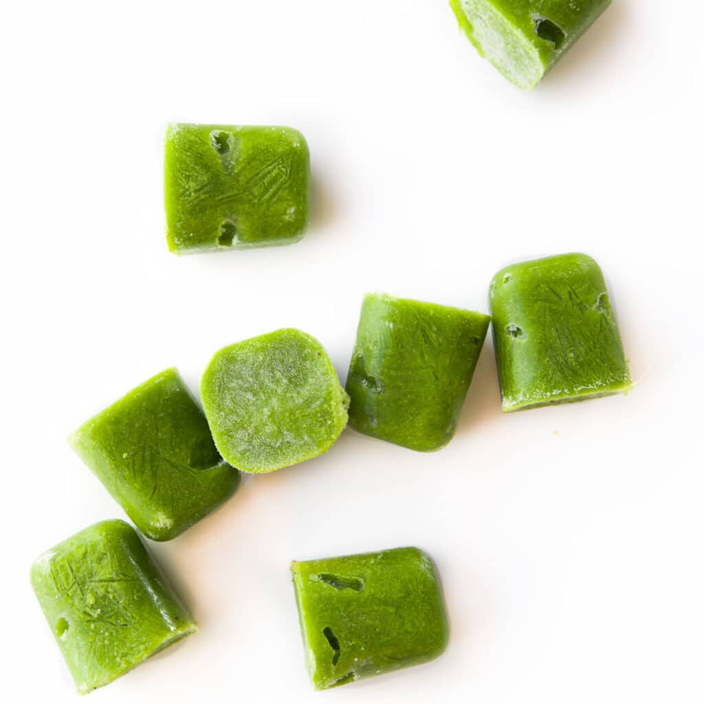 Frozen Green Bean Puree Cubes on White Background.