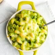 Pinterest Pin with Image of Green Mac and Cheese in Small Dish Topped with Cheese.