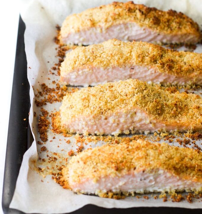 Freshly cooked parmesan crusted salmon fillets on baking tray