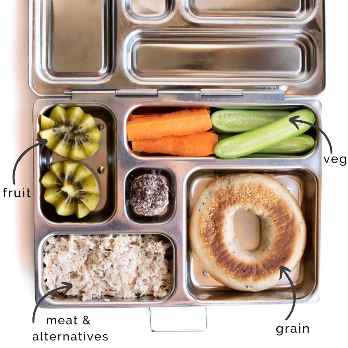 Metal Bento Lunchbox with Bagel Half, Tuna Salad, Kiwi, Carrot and Cucumber Sticks and a Cherry Bliss Ball.