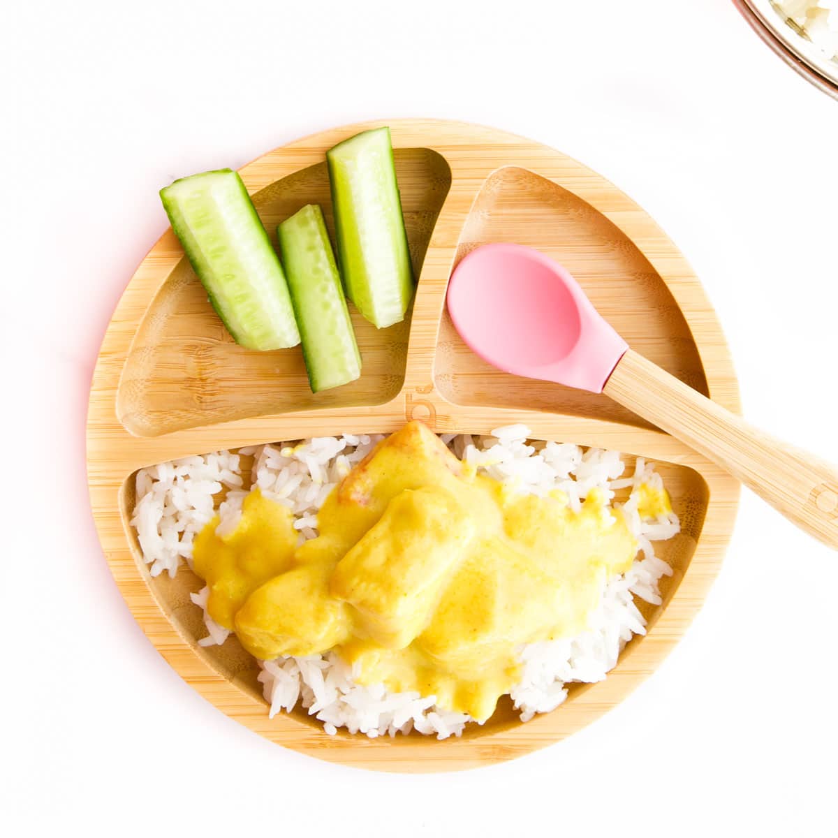 Mango Chicken Curry in Baby Bowl Served on  Rice with a Side of Cucumber Sticks. 