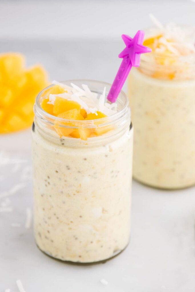 Two Jars of Mango Overnight Oats Topped with Fresh Mango