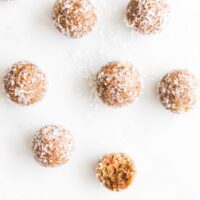 Top Down Shot of Nut Balls on Marble Surface. One with Bite Removed