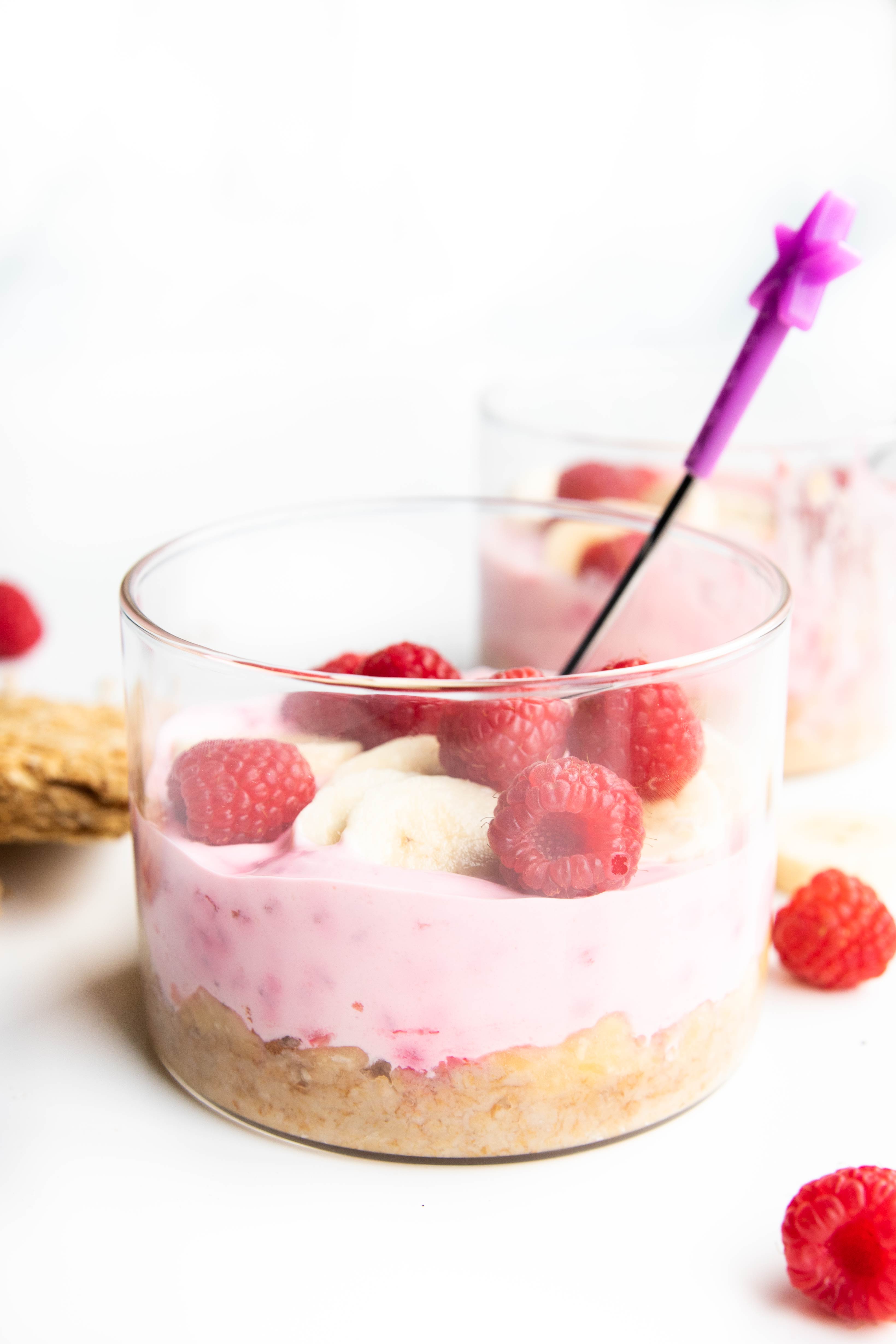 Side Shot of Overnight Weetbix in Glass Container with Spoon.