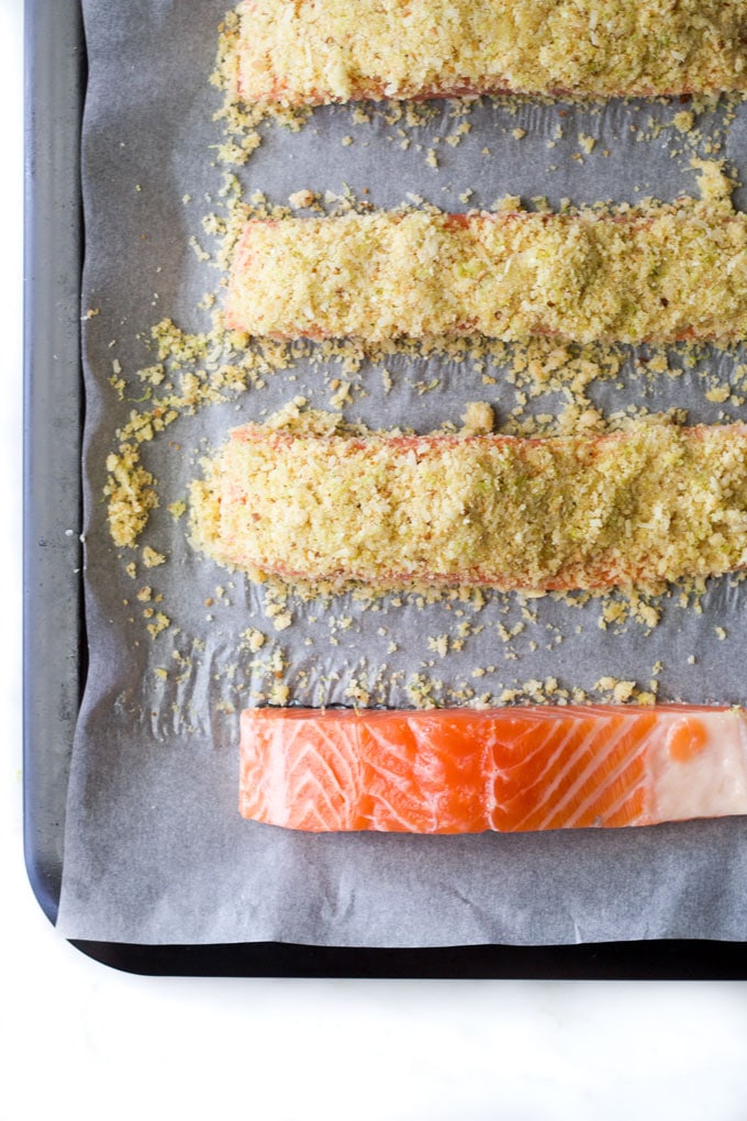 raw salmon fillets on baking tray before and after parmesan crust pot on top