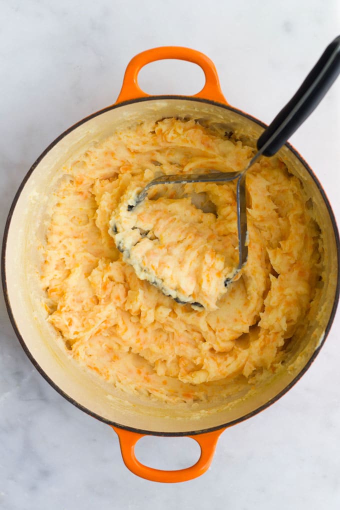 Potato and Carrot Mash being Mashed in Pan