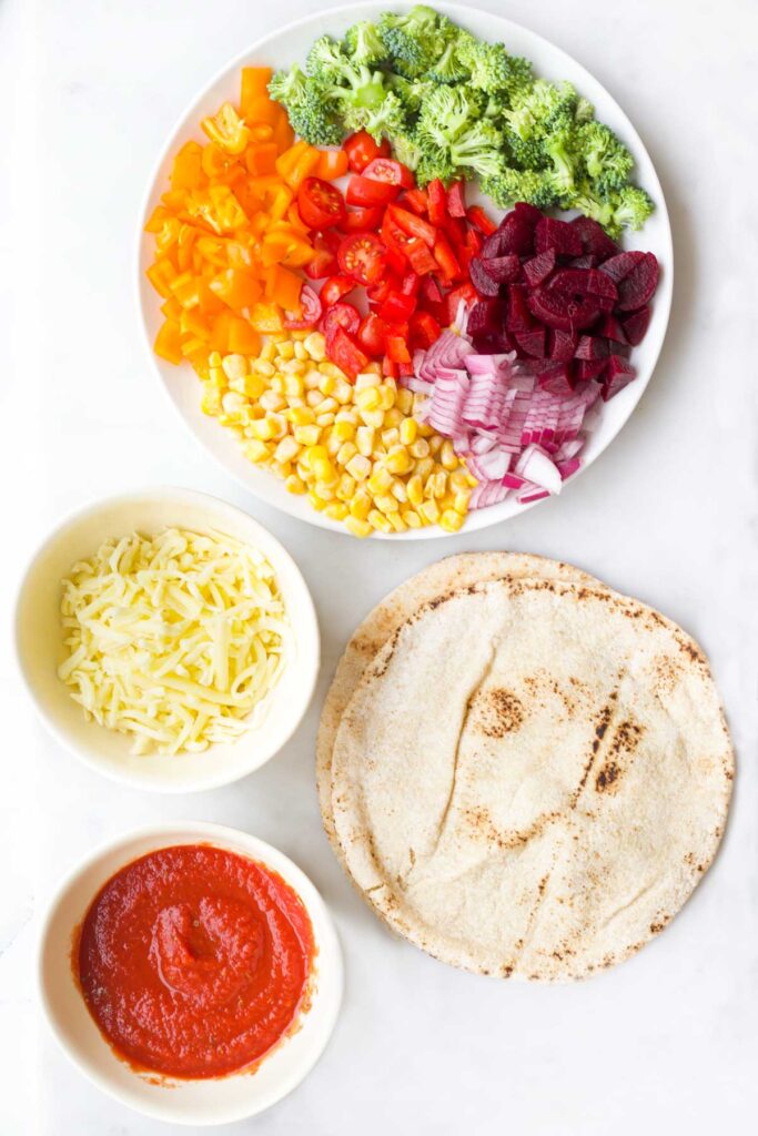 Top Down View of Ingredients to Make Rainbow Pitta Pizzas