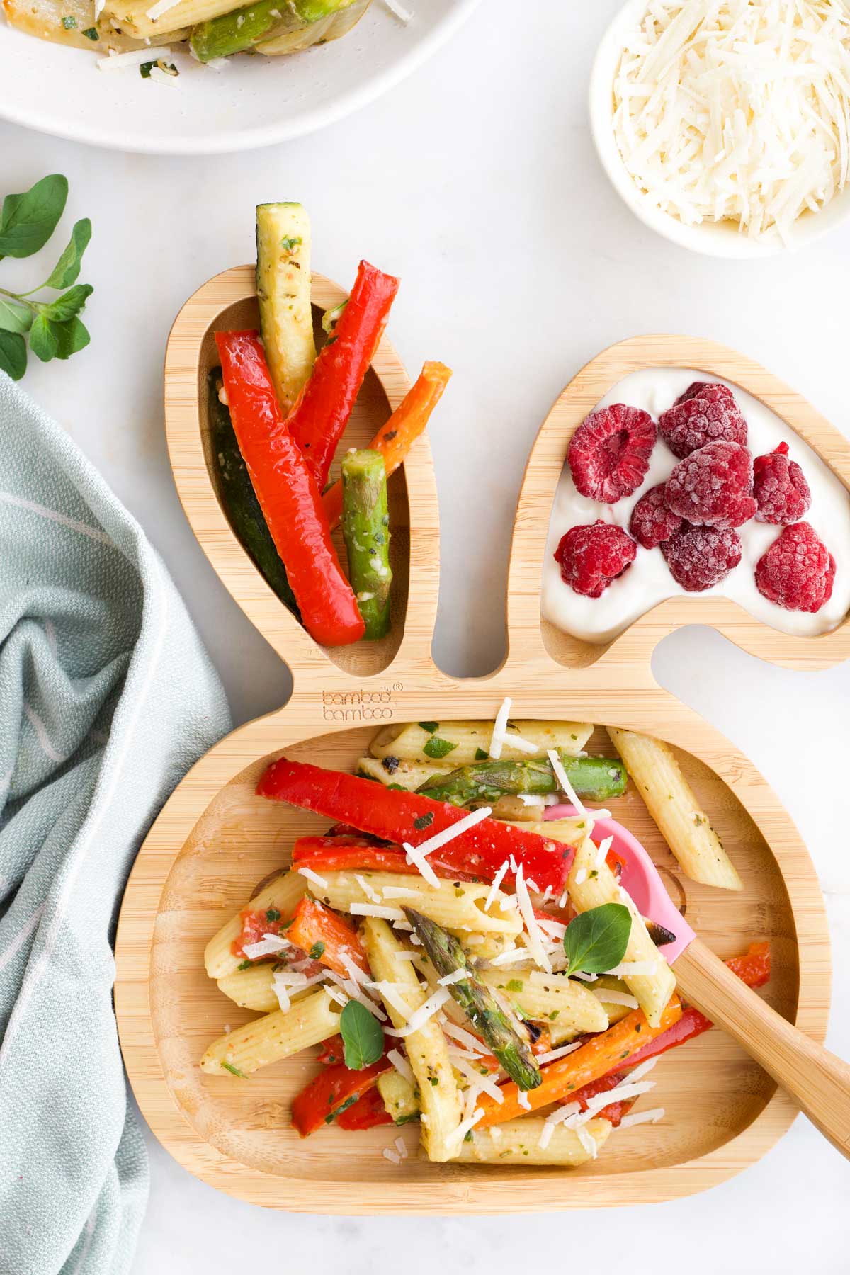 Roasted Vegetable Pasta on Bunny Shaped Toddler Plate With Extra Roasted Vegetables and Yoghurt with Raspberries