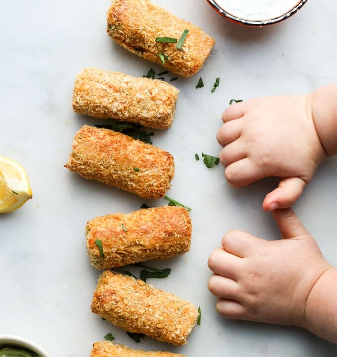 Toddler Hands Next to Line of Salmon Croquettes