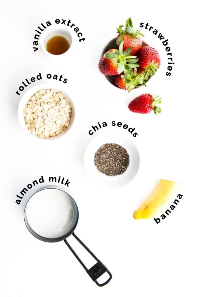 Flat Lay Shot of Ingredients Needed to Make Strawberry Overnight Oats (Labelled)