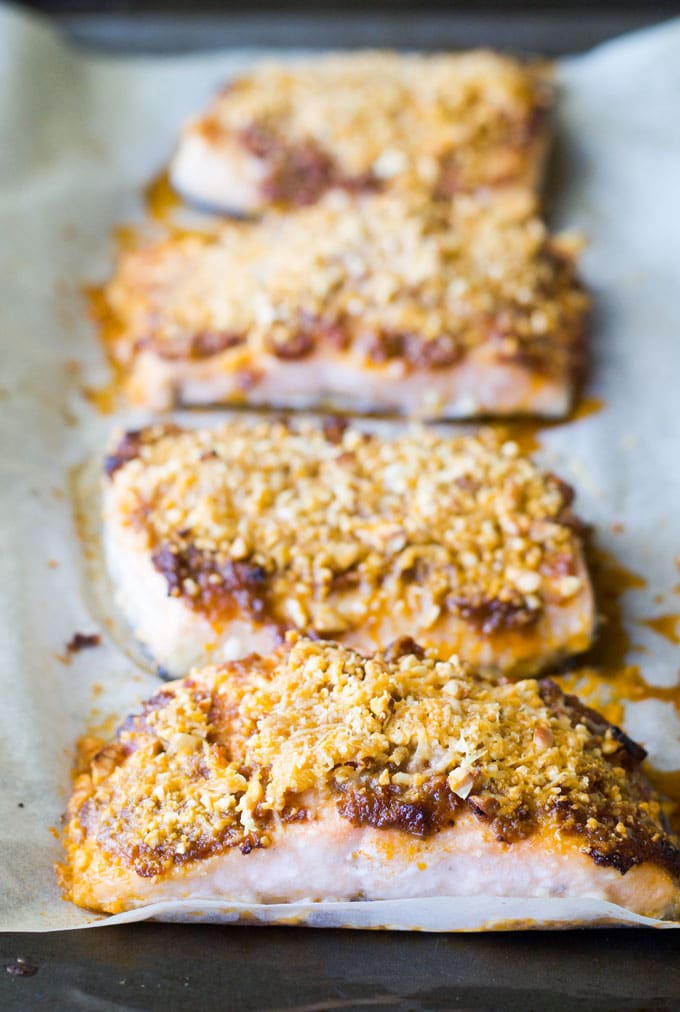 Baked salmon fillets with a sundried tomato crust on a baking tray