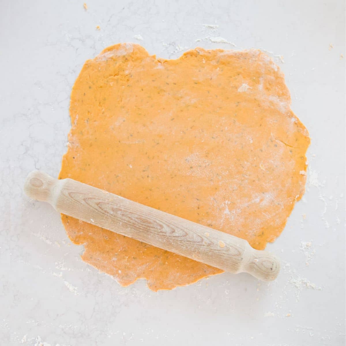 Sweet Potato Cracker Dough Rolled Out on Surface with Rolling Pin. 