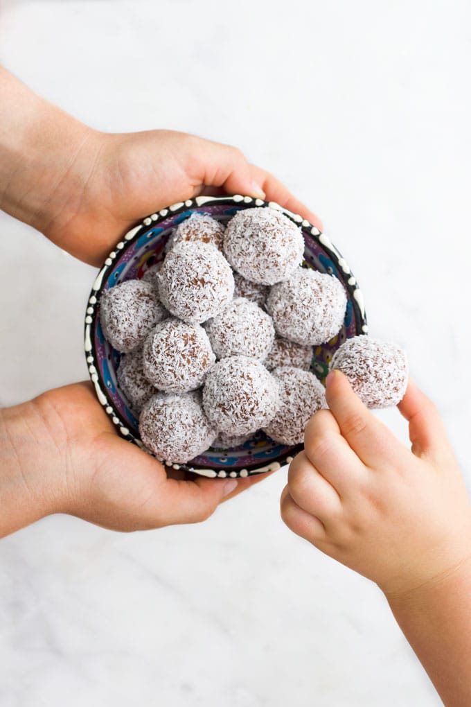 Child Grabbing a Sweet Potato Truffle from Bowl