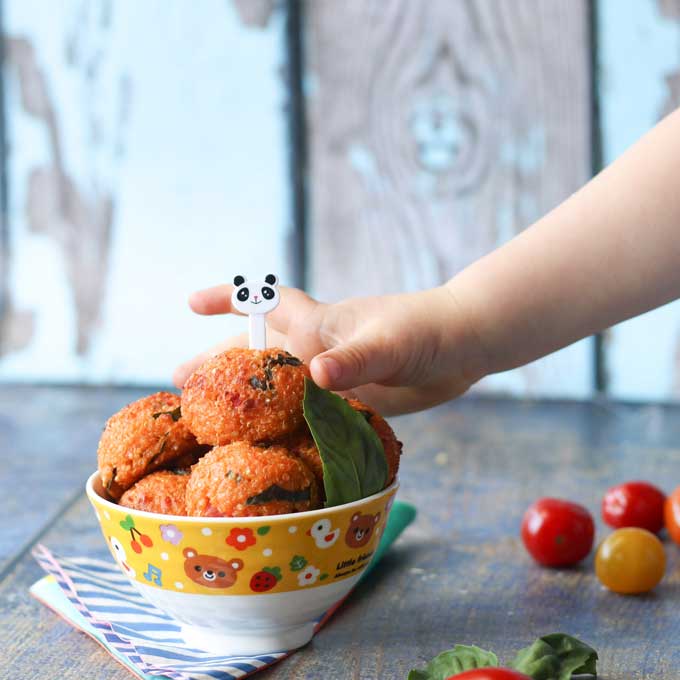 Child Grabbing Quinoa Ball from Bowl