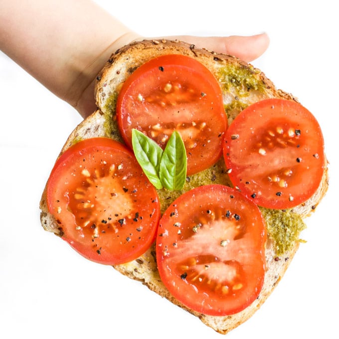 Toast Spread with Pesto and Topped with Slices of Tomato