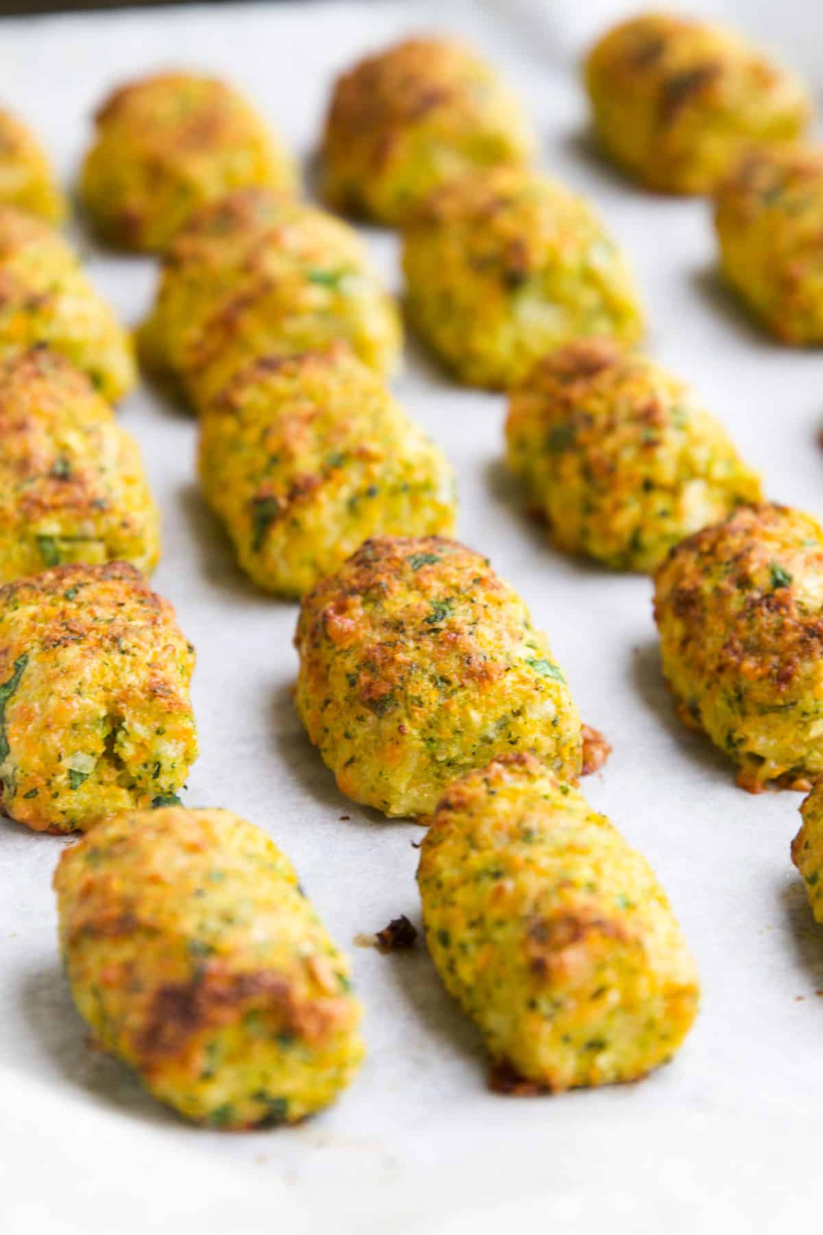 Side on Shot Of Cooked Veggie Tots on Baking Tray.