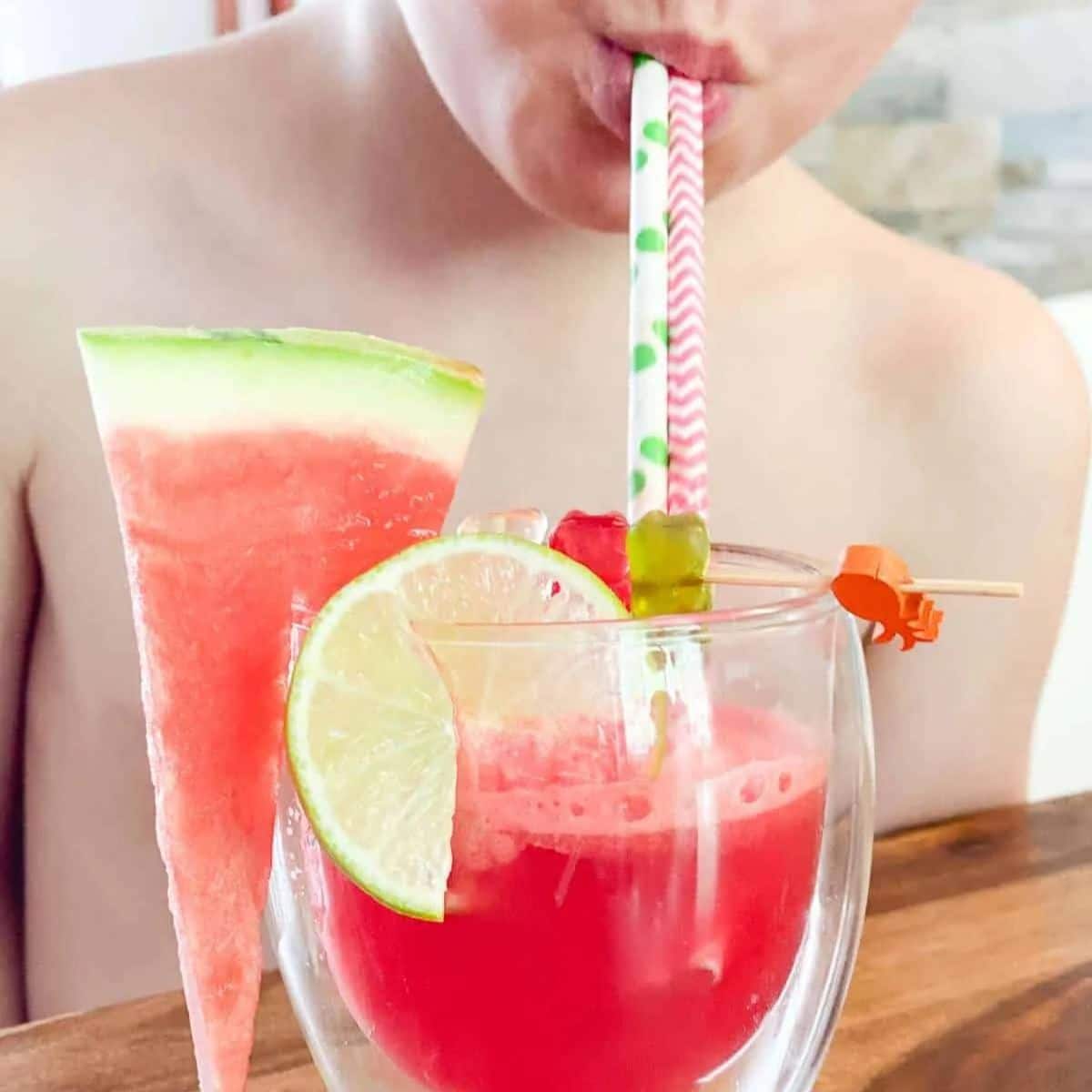 Child Drinking Watermelon Punch From Straws.