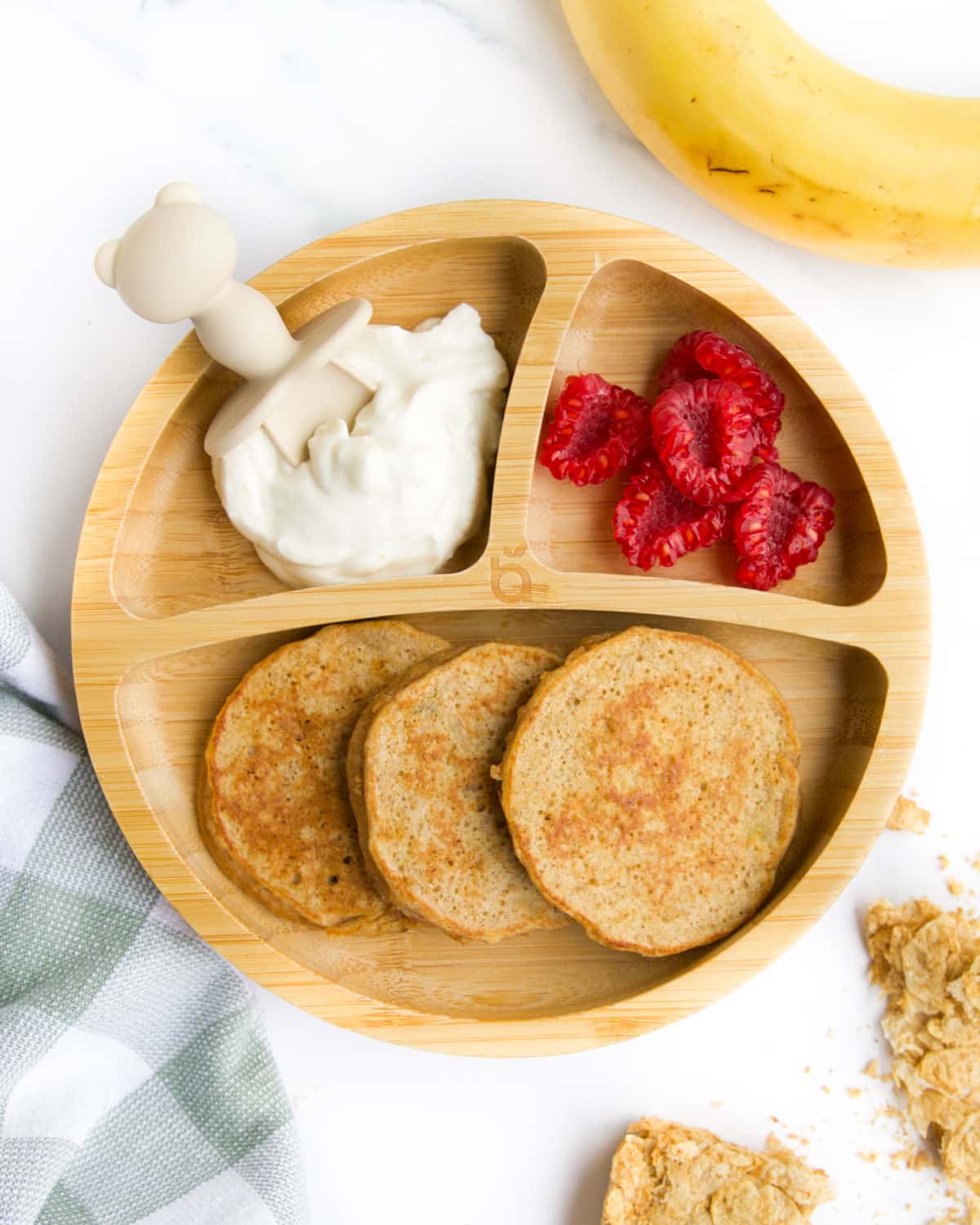 Weetbix Banana Pancakes on Baby Plate Served with Raspberries and Yogurt.